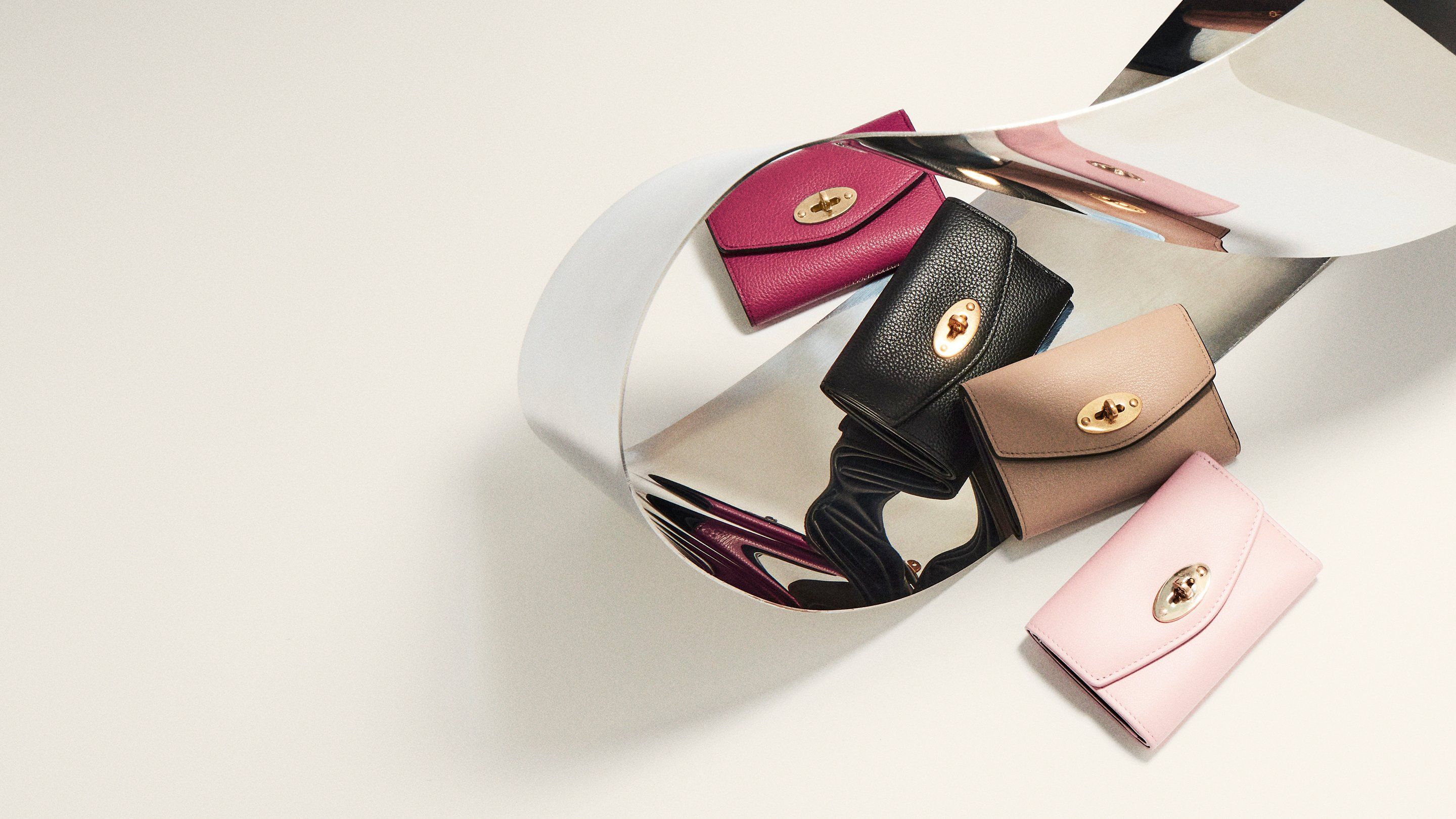 group of Mulberry Darley folded multicard wallets in powder rose, maple, black and Mulberry pink